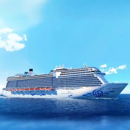Large modern cruise ship with blue hull sailing on calm blue sea under clear sky