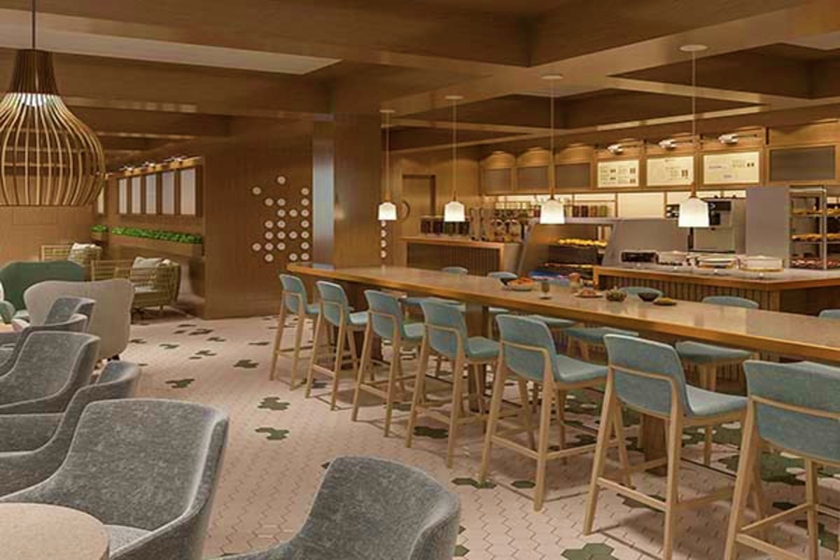 Modern cruise ship cafe with wooden bar counter, bar seating, lounge chairs, pendant lighting, and open kitchen design in war