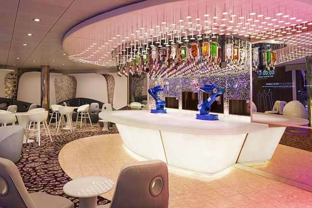 Modern cruise ship atrium with white reception desk, blue robotic arms, hanging colorful flags, curved ceiling with grid ligh