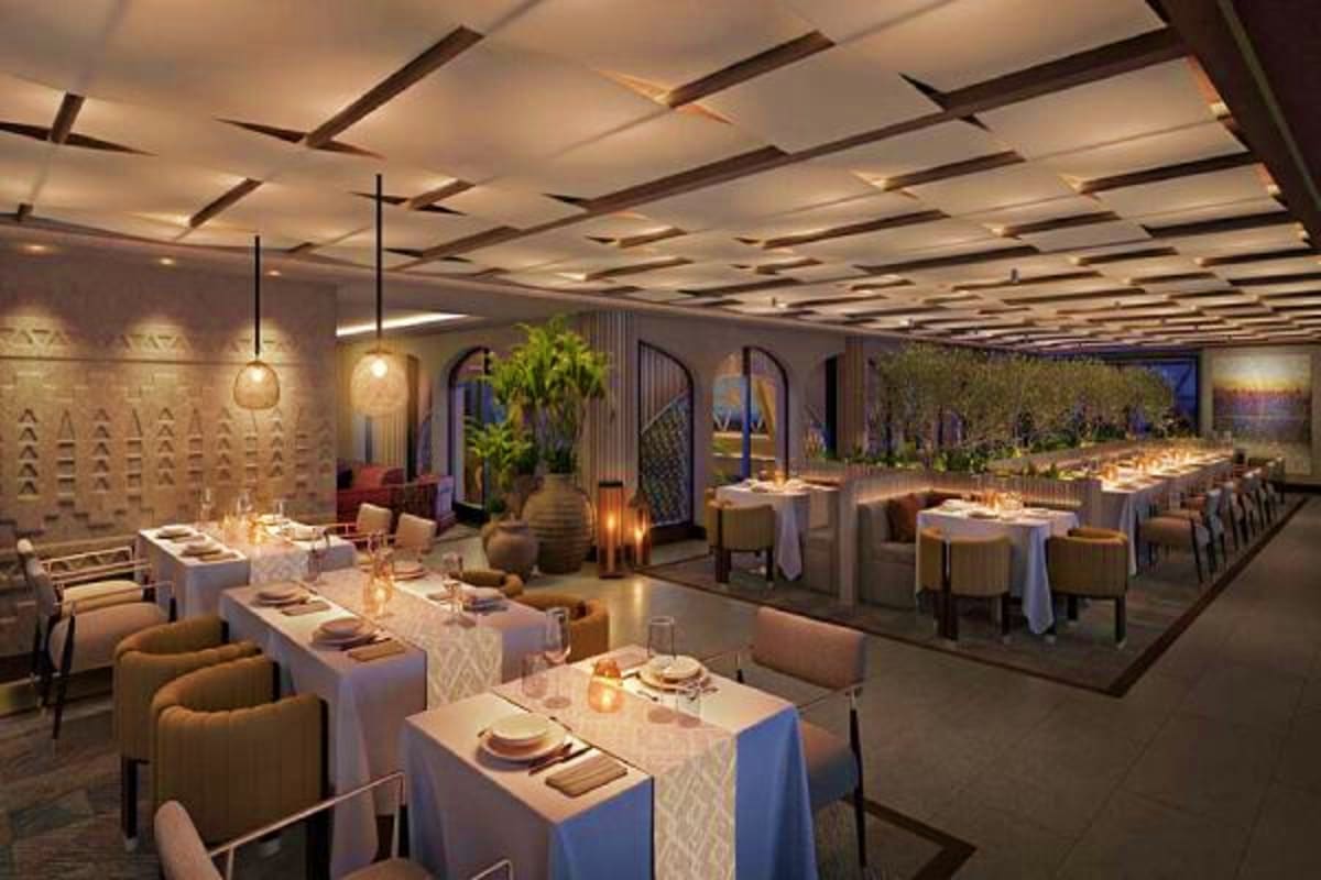 Modern upscale dining room with elegant table settings, pendant lighting, coffered ceiling, and green plant accents