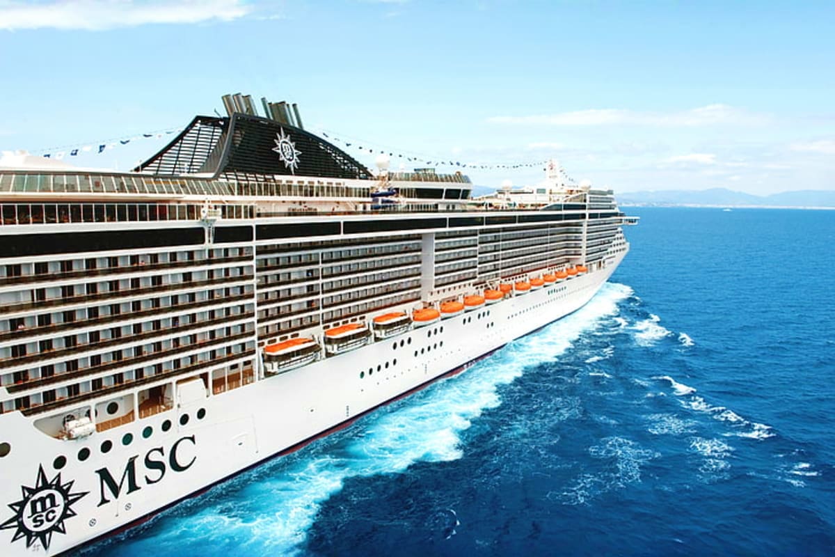 MSC Splendida cruise ship sailing on blue ocean water with wake trailing behind