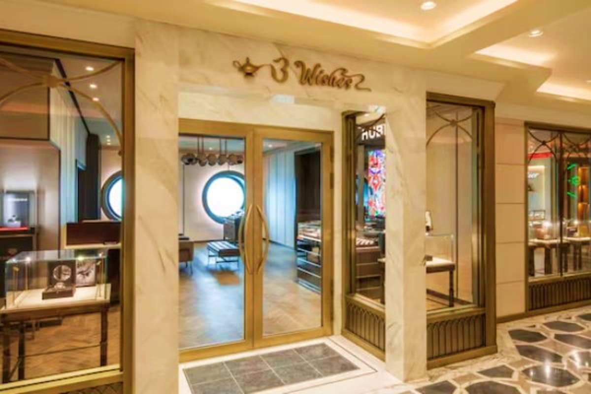 Magical Singapore and Langkawi Escape Luxury cruise ship corridor with gold-framed glass doors, marble walls, and elegant hallway leading to cabin interior with ro