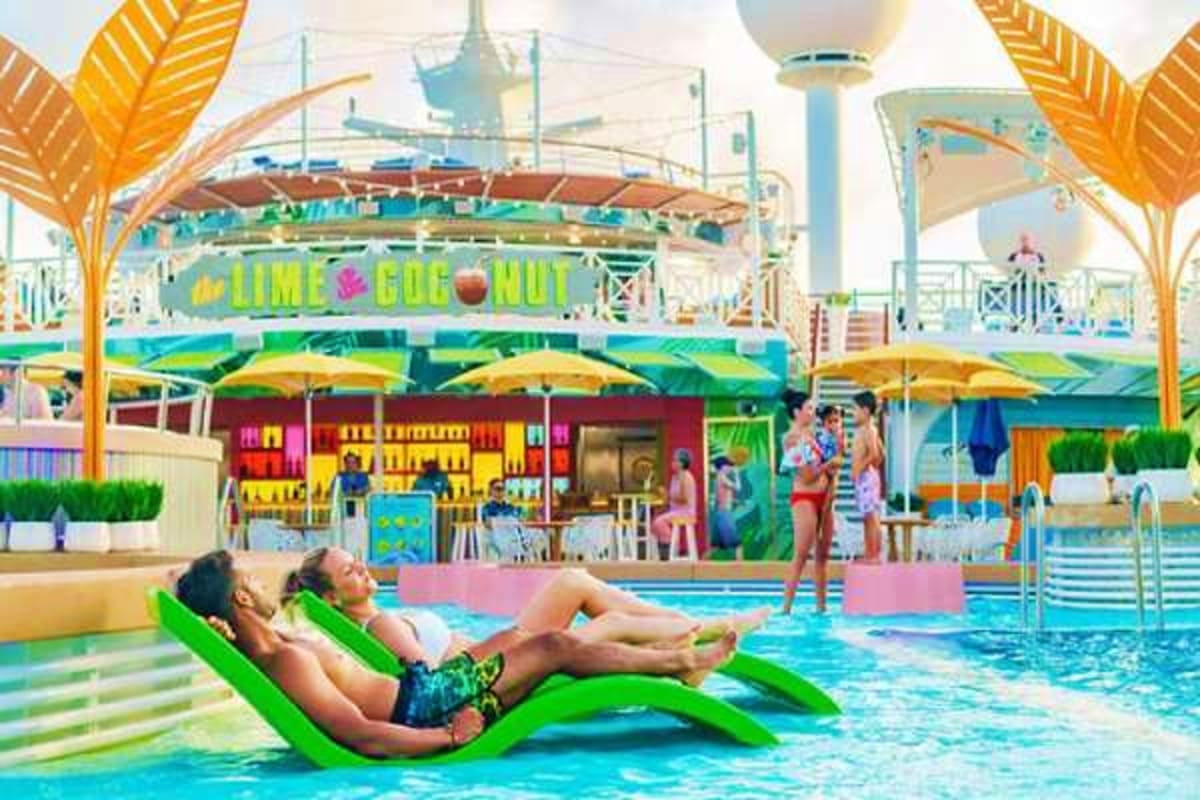 Two children relaxing on bright green pool loungers in a tropical water park with Lime & Coconut bar and colorful umbrellas i