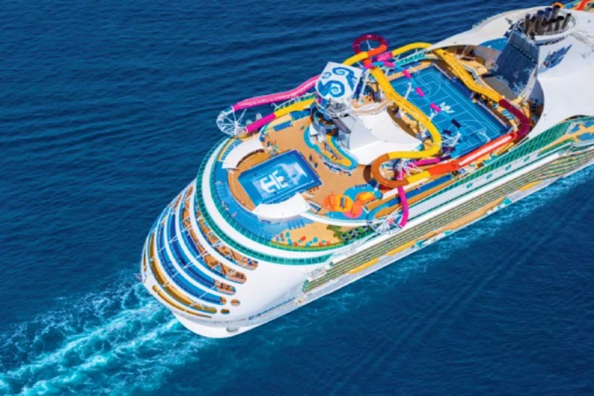 Aerial view of colorful Asian Horizons cruise ship with blue water slides and recreational deck areas on ocean water
