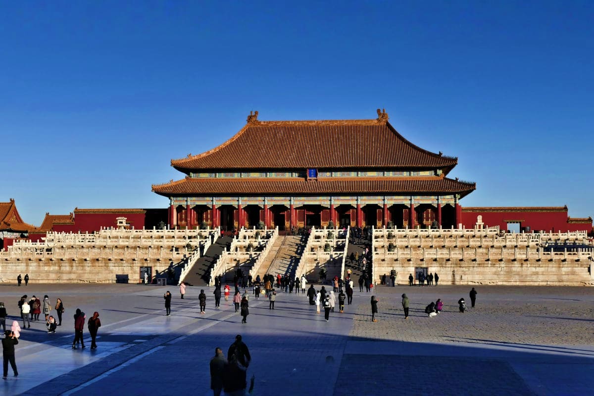 Hall of Supreme Harmony in the Forbidden City, Beijing, with visitors in the courtyard and clear blue sky