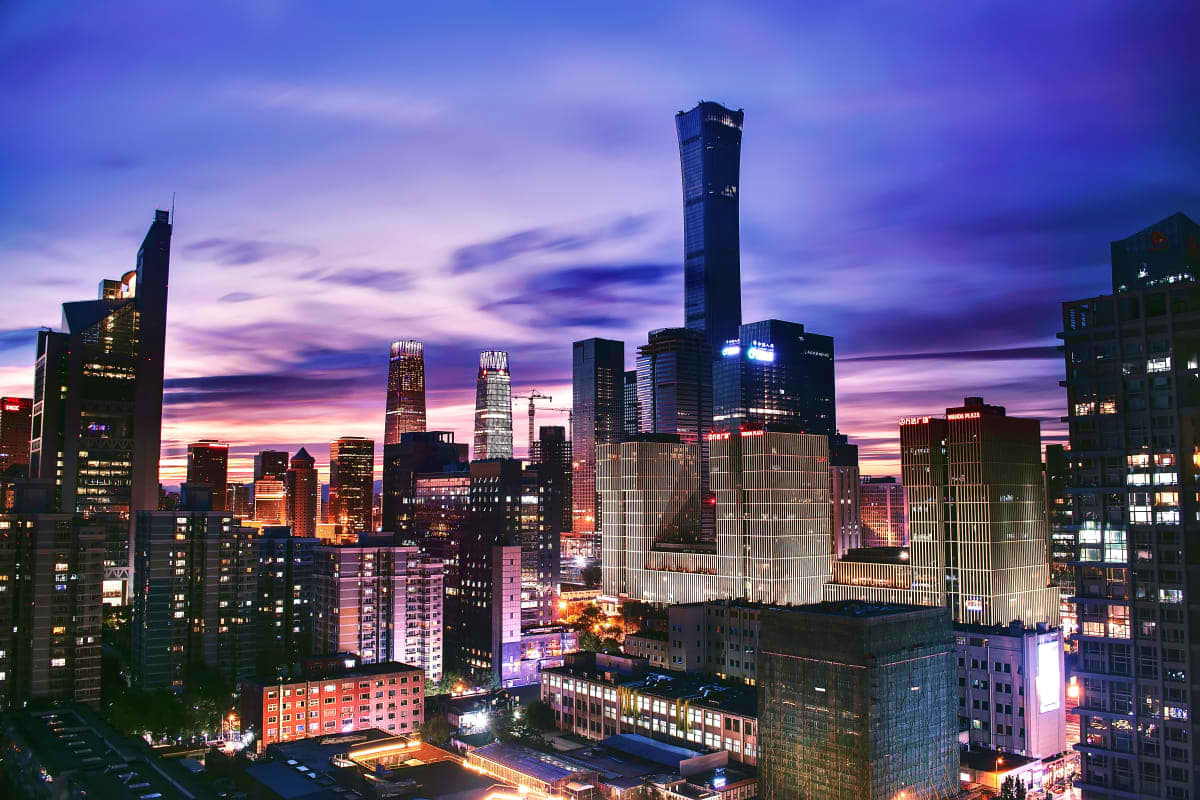 Chicago skyline at twilight with illuminated skyscrapers and purple-pink sunset sky reflecting off downtown buildings