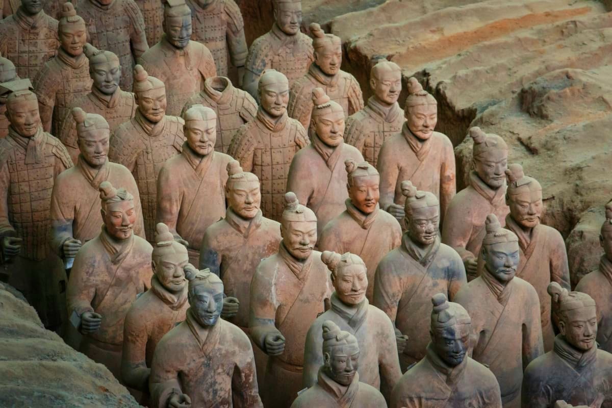 Terracotta Army soldiers in formation at the Xi'an archaeological site in China, showing detailed clay warrior statues from a