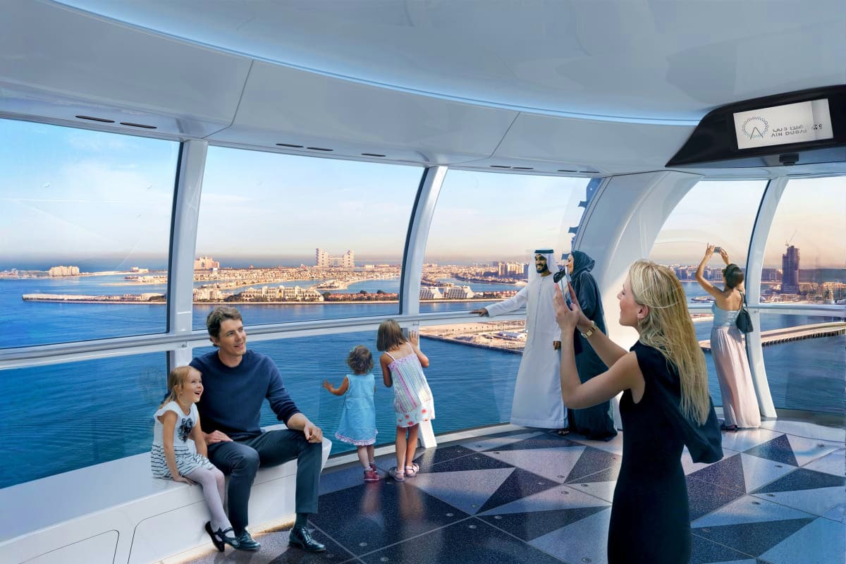 Families enjoying panoramic views of Dubai coastline and cityscape from inside the Ain Dubai observation wheel cabin with flo