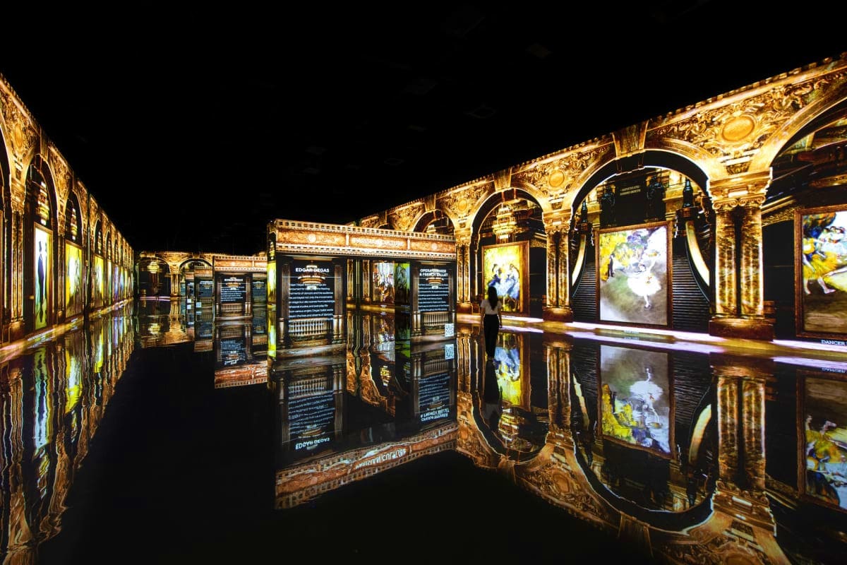 Arte Museum Dubai Illuminated gallery interior at Arte Museum Dubai featuring ornate gold-framed displays and artwork reflected on polished bla