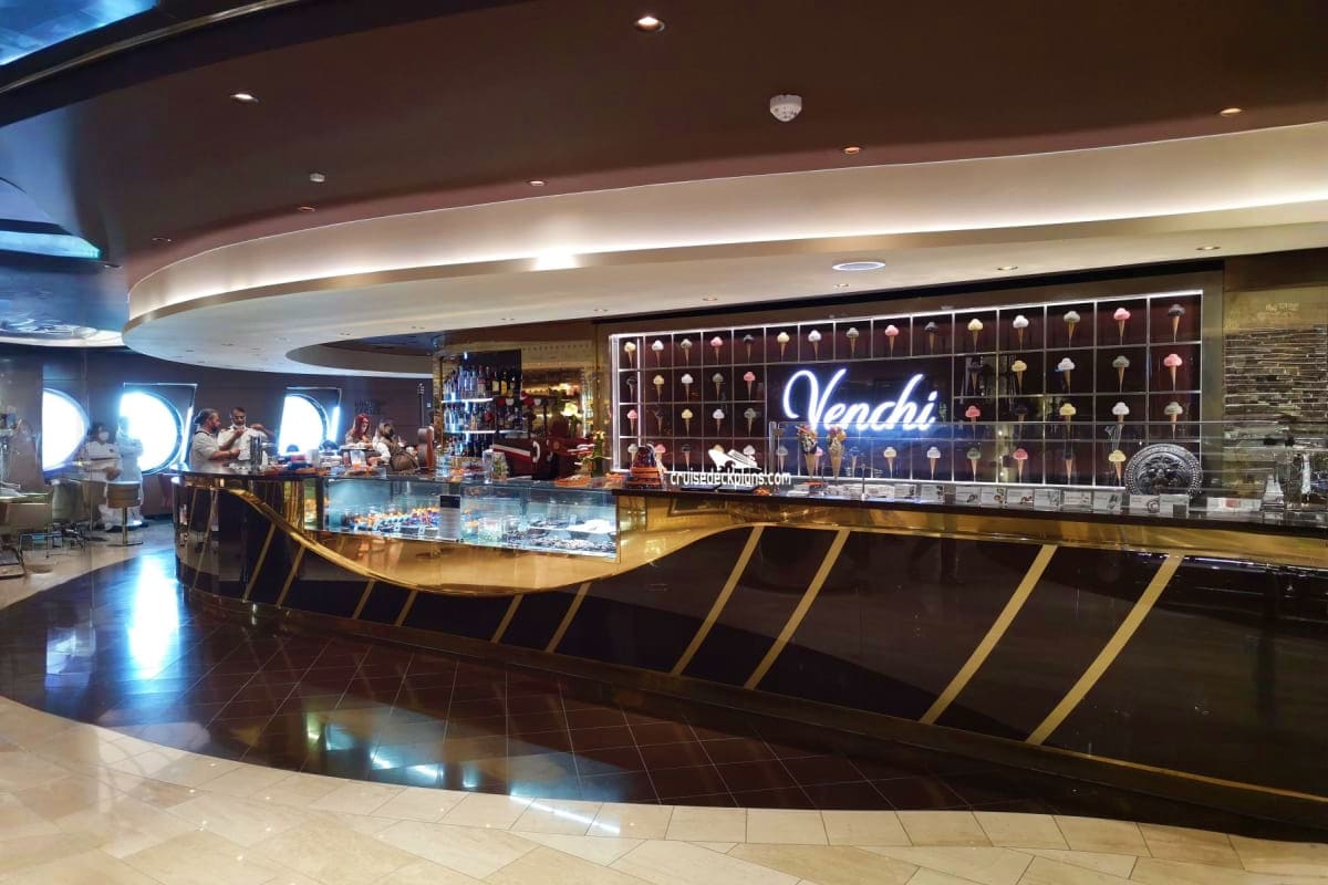 Venchi jewelry store interior on MSC Seaview cruise ship with curved counter, neon signage, and display cases