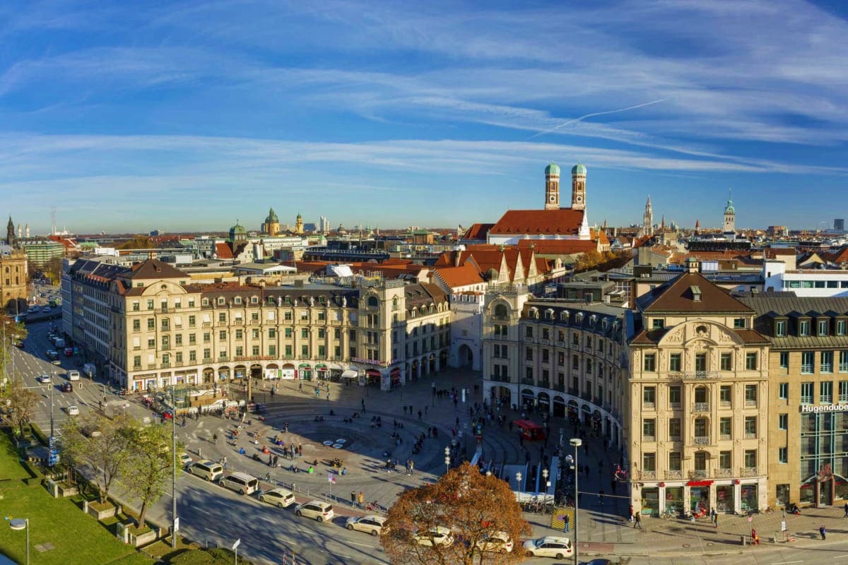 Discover Munich Old Town Guided Walking Tour Aerial view of Munich Old Town's Marienplatz square with historic buildings, Frauenkirche church with twin towers, and city s