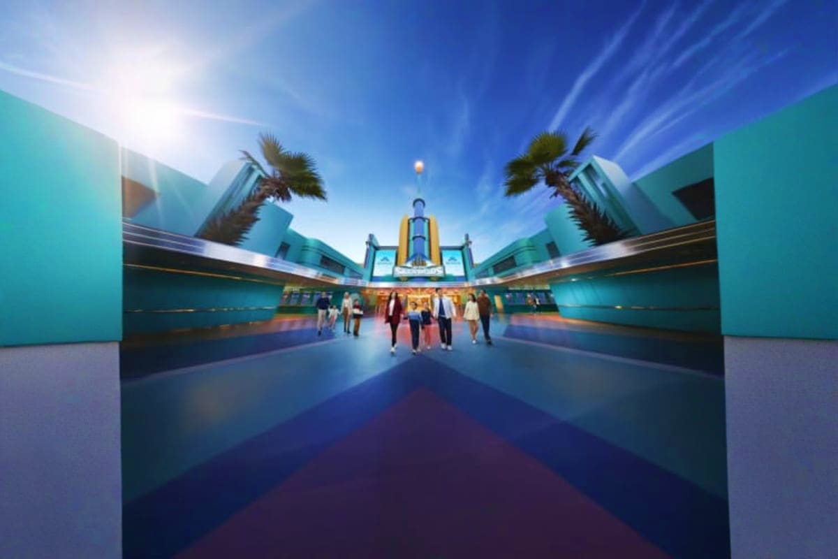 Symmetrical view of Genting Skytropolis Indoor Theme Park entrance with turquoise walls, central tower, palm trees, and visit