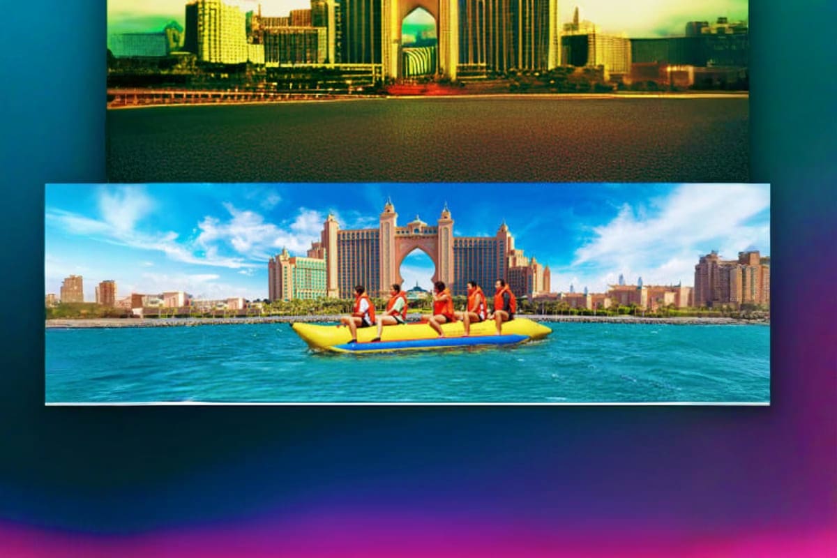 Five people in orange life jackets riding yellow banana boat with Atlantis The Palm hotel in background, Dubai waterfront