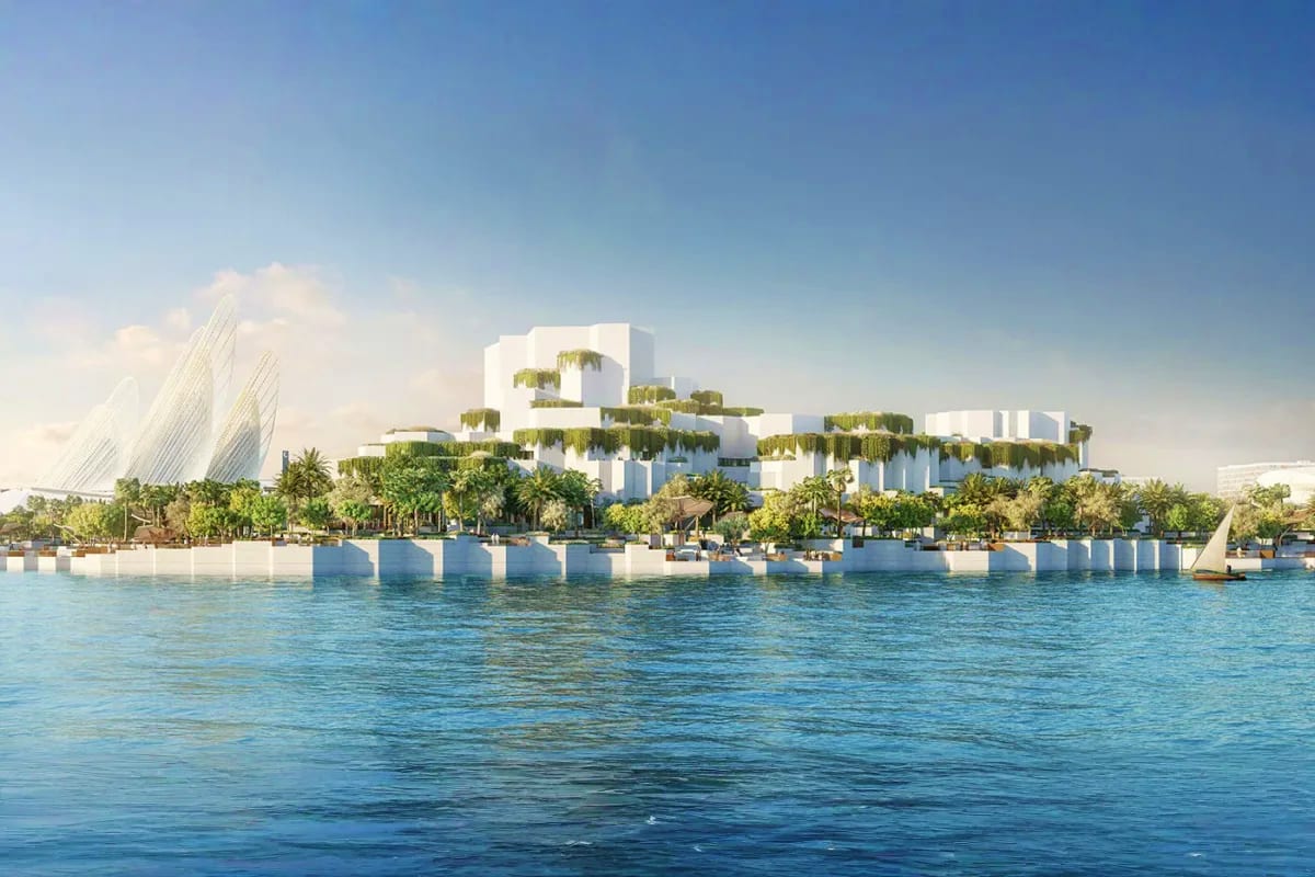 Modern white Natural History Museum building with green rooftop gardens viewed from turquoise waterfront in Abu Dhabi