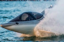 Seabreacher submersible watercraft launching through ocean waves in Dubai, creating large water spray