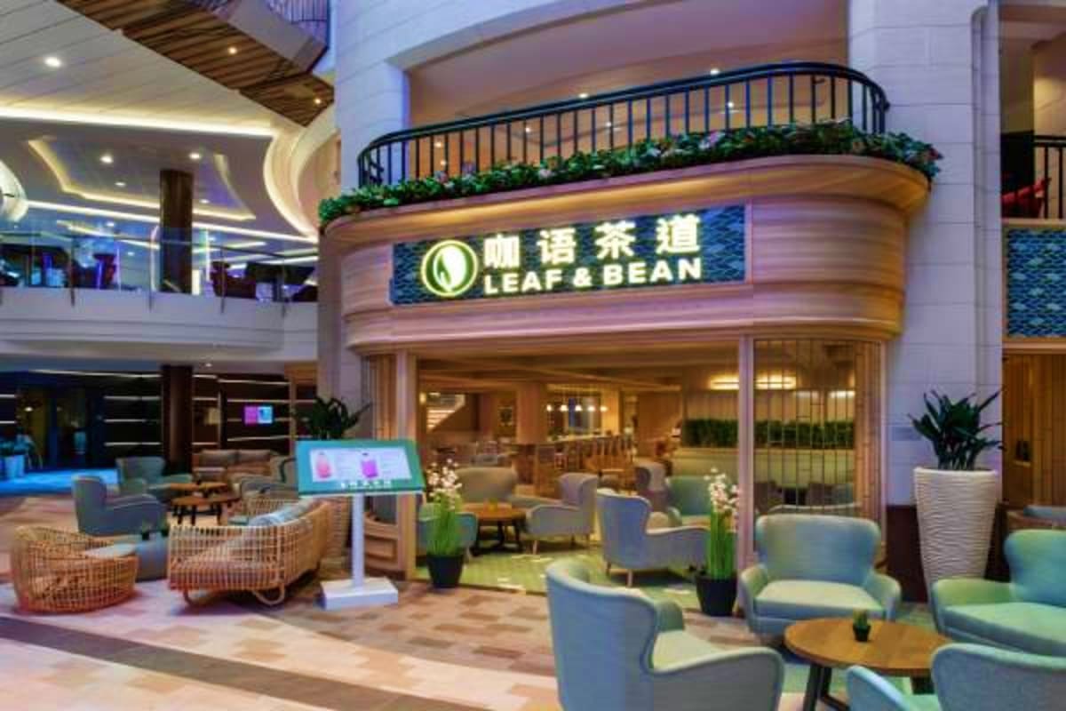 Leaf & Bean tea café interior in modern shopping mall atrium with seating area and curved storefront signage