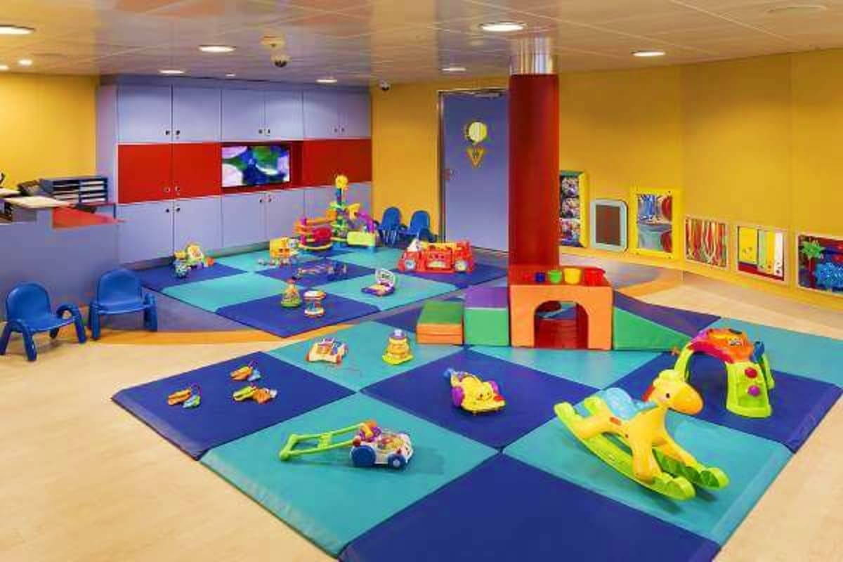 Modern colorful daycare or children's playroom with foam mats, toys, and play structures for infants and toddlers