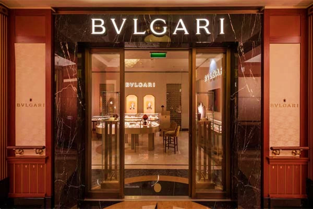 Bvlgari luxury jewelry boutique storefront with illuminated signage, glass doors, and elegant interior display on Disney Fant