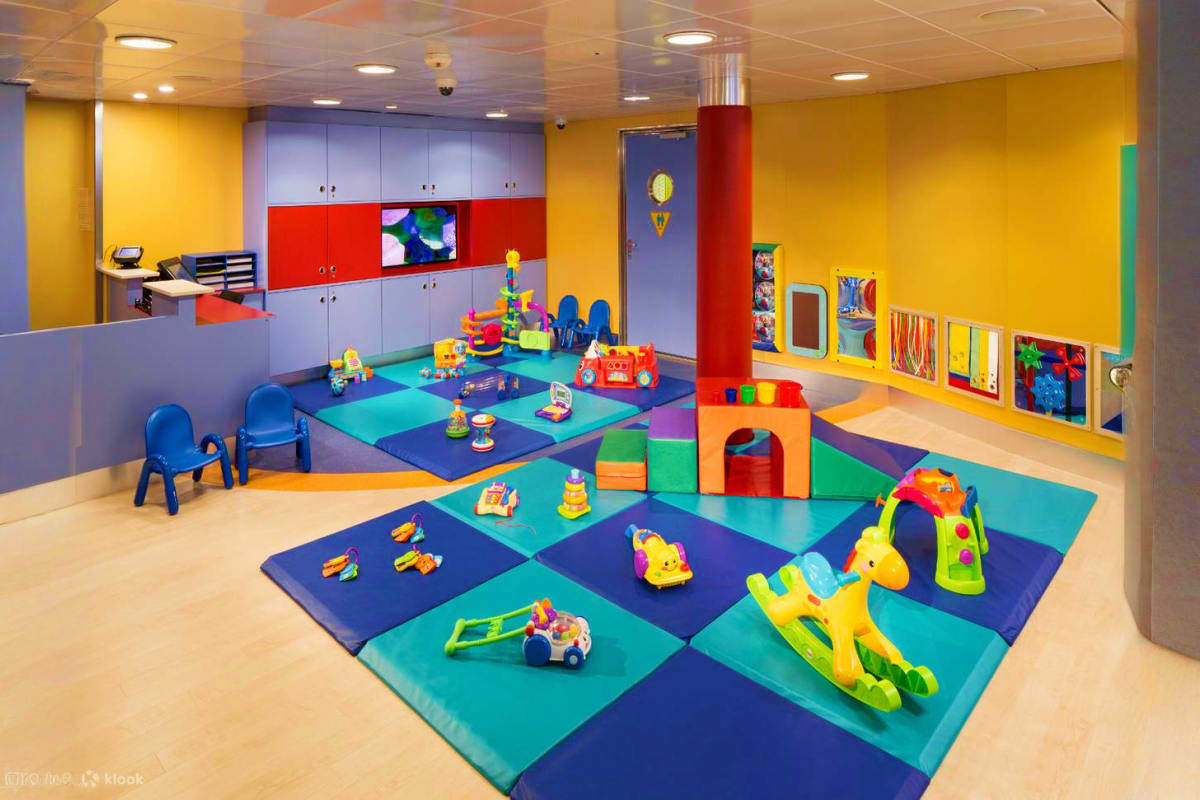 Four Nights Asia Pacific Discovery Colorful indoor daycare room with foam mats, toys, blocks, and play equipment designed for young children