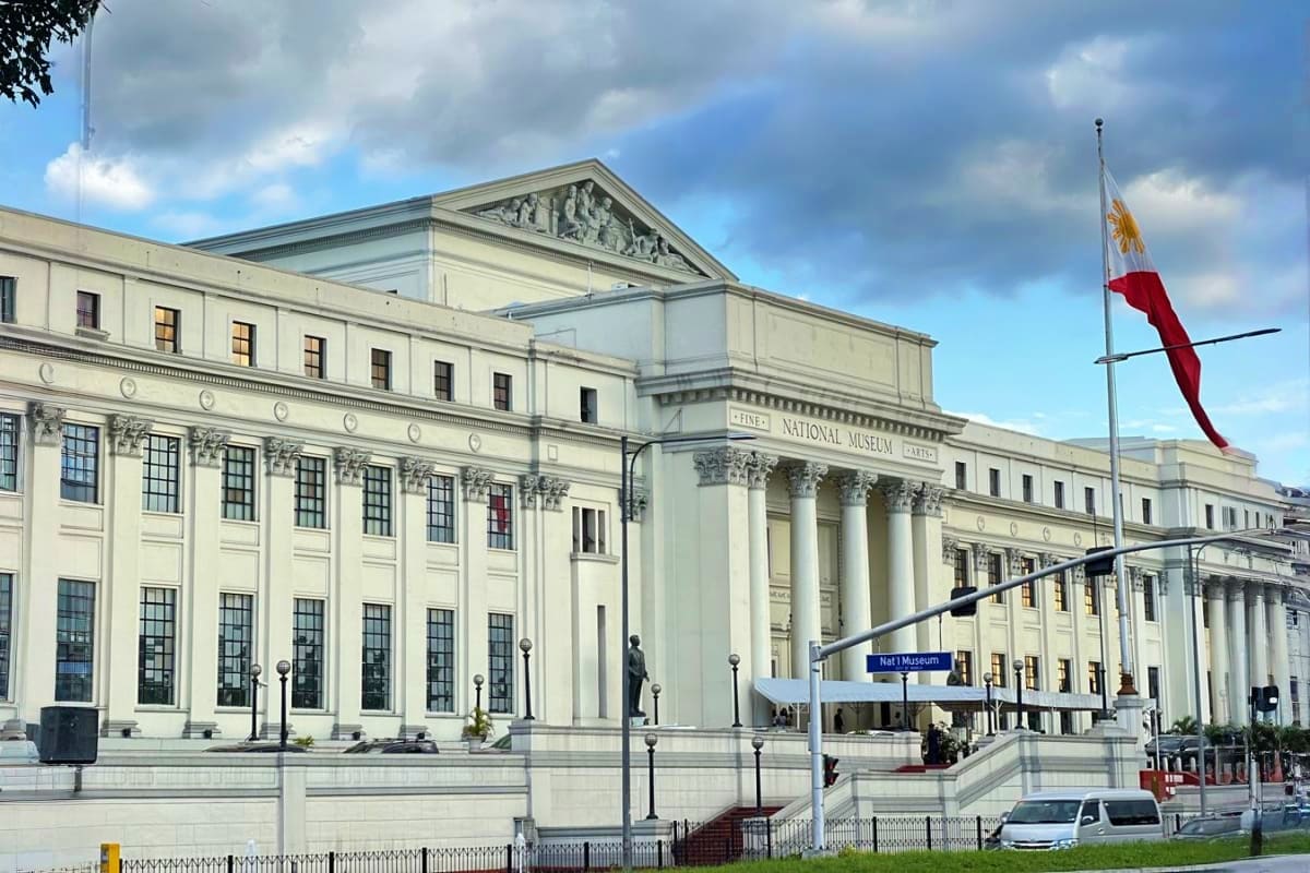 National Museum building in Manila with neoclassical architecture, white columns, and Philippine flag, representing cultural 
