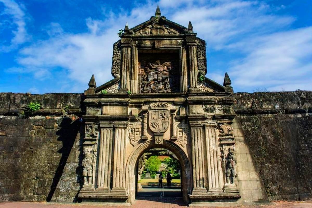 Historic stone fortress gateway with ornate baroque architecture and detailed carved relief, Fort Jefferson Philippines