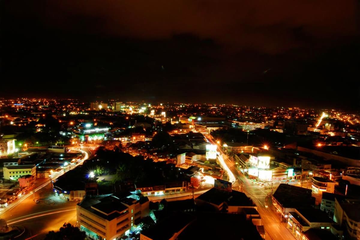 Aerial nighttime view of Davao city illuminated with street lights and buildings, showcasing the urban landscape destination.