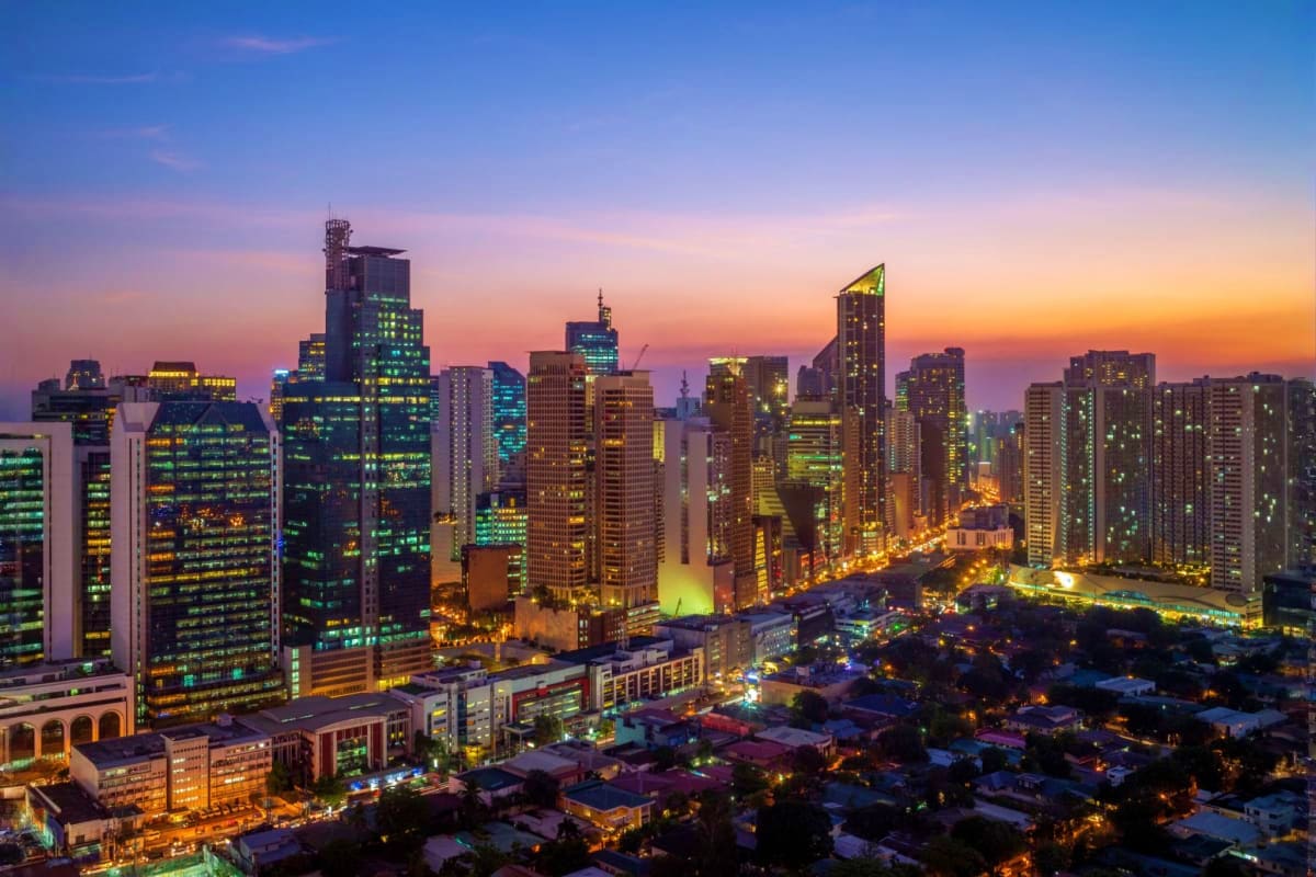 Chicago skyline at dusk with illuminated skyscrapers and city lights reflecting golden hour sunset