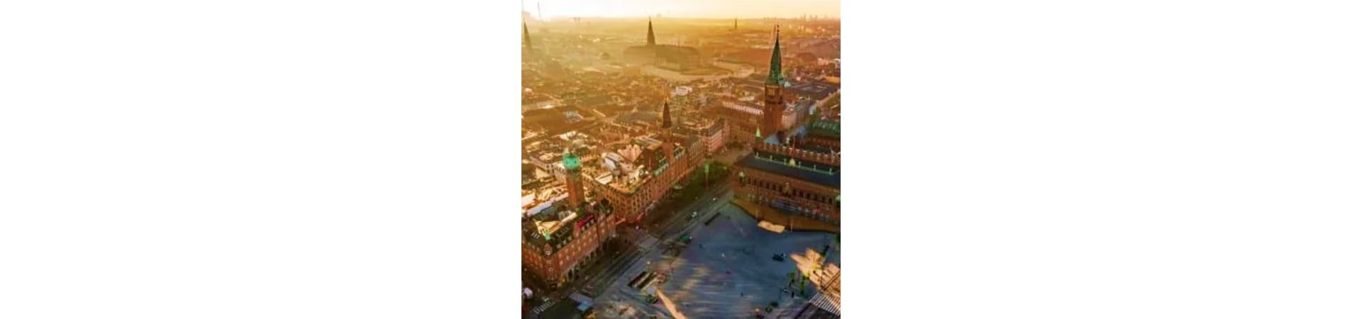 Aerial view of Copenhagen city center at golden hour with historic buildings and town square