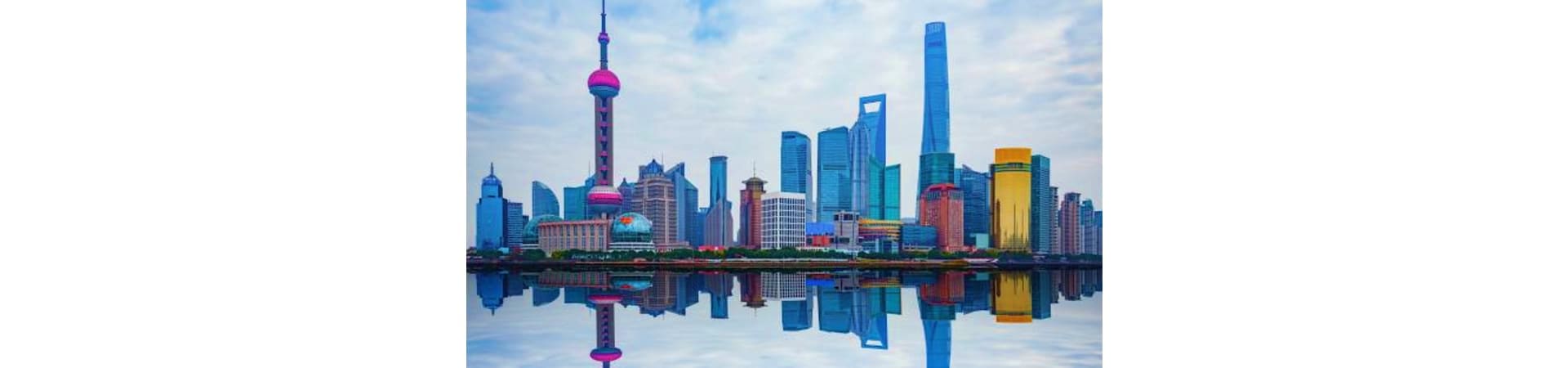Shanghai skyline featuring Oriental Pearl Tower and modern skyscrapers reflected in water