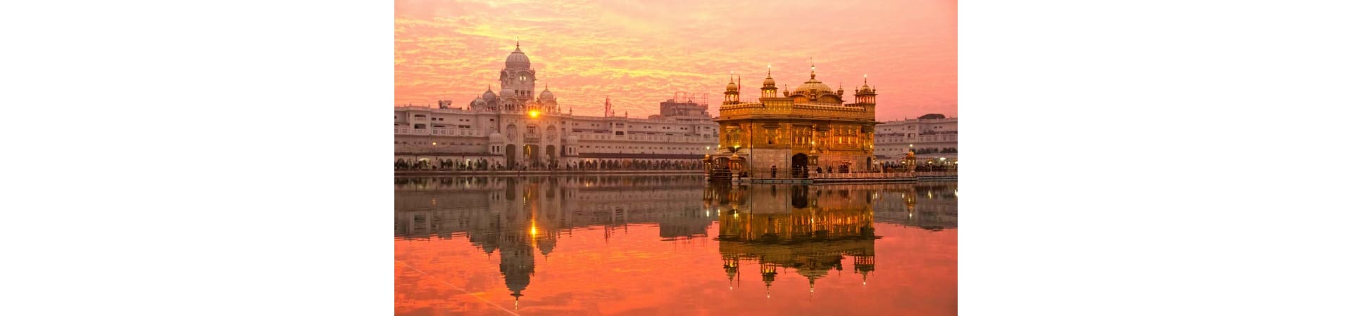 Golden Temple at sunrise reflected in the sacred pool, Amritsar India