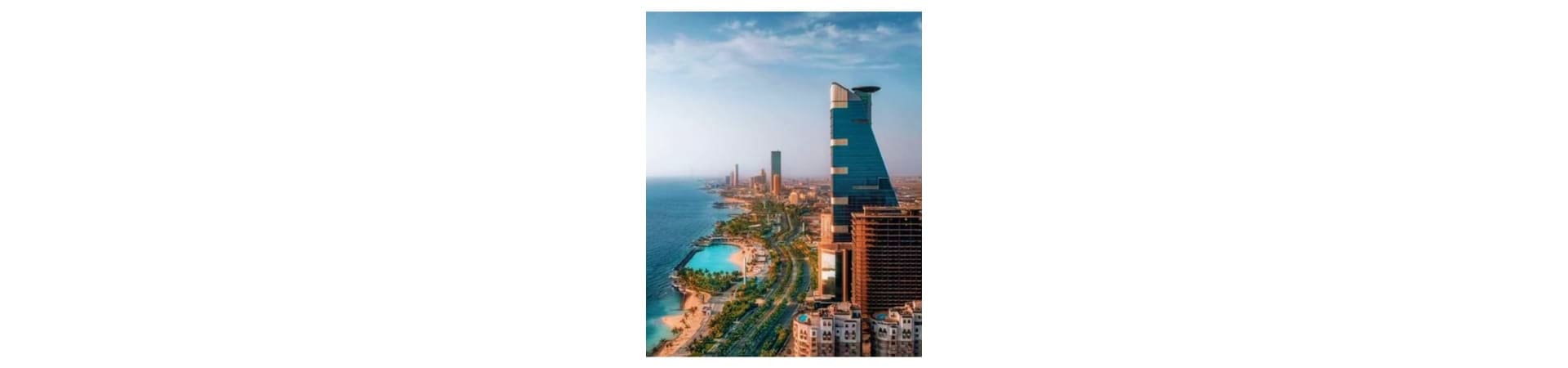 Aerial view of Jeddah waterfront with beachfront resort and modern skyline along the Red Sea coast
