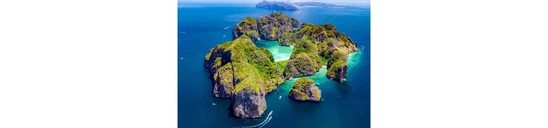 Aerial view of limestone islands with turquoise lagoon in Krabi, Thailand surrounded by blue sea