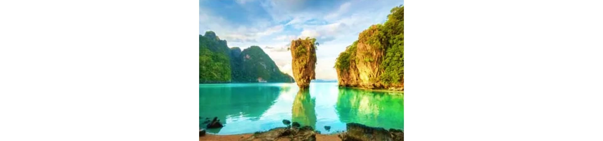 Emerald lagoon with towering limestone rock formation surrounded by lush green cliffs in Koh Samui, Thailand