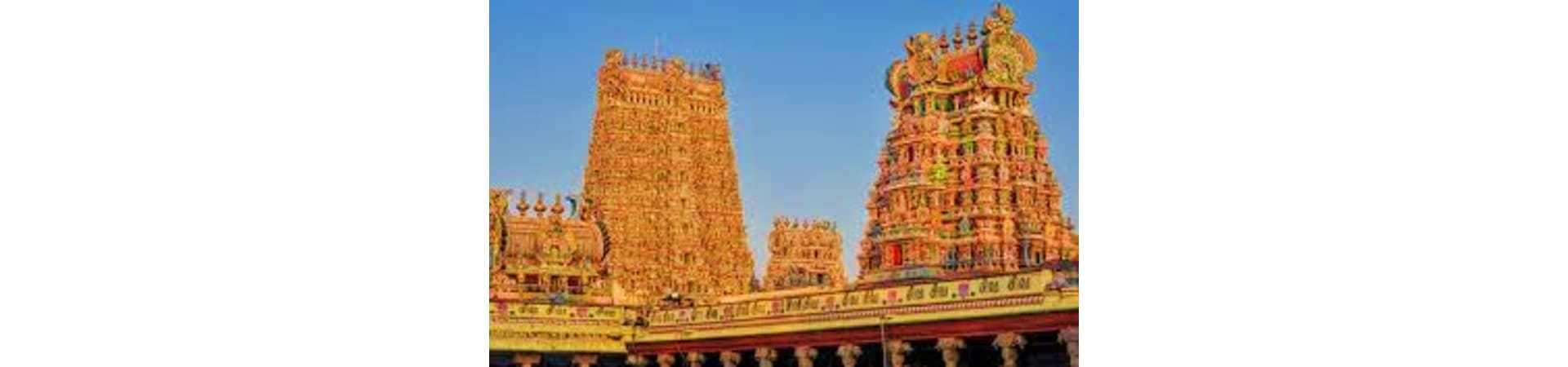 Meenakshi Temple in Madurai with ornate colorful gopurams against blue sky