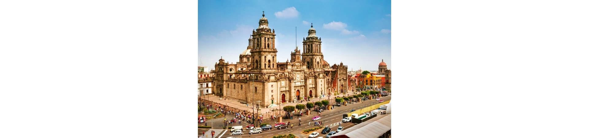Mexico City Metropolitan Cathedral with twin bell towers and colorful colonial buildings in historic downtown plaza
