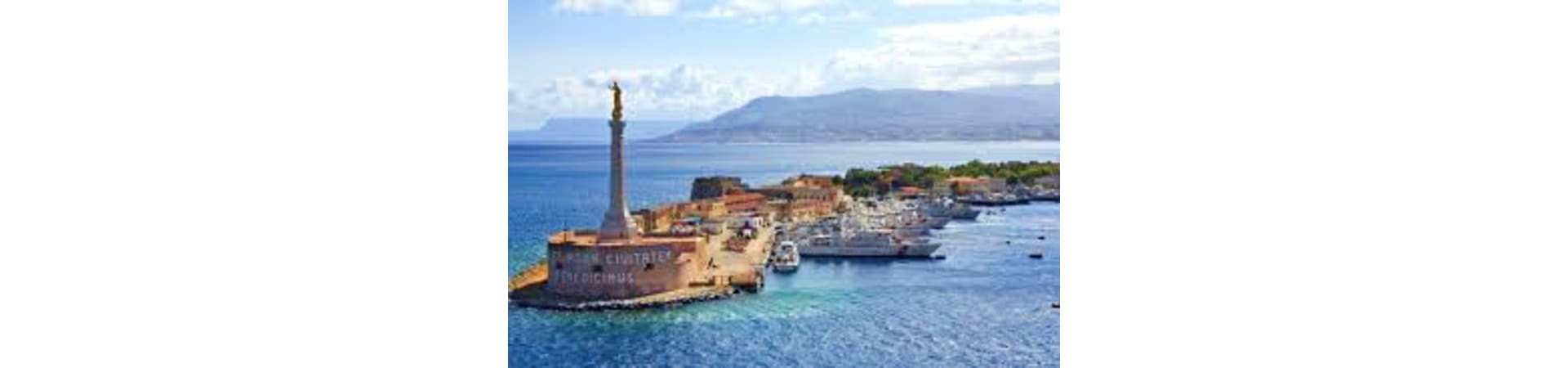 Venetian fortress with lighthouse overlooking Messina harbor and moored ships, with Calabria mountains visible across the str