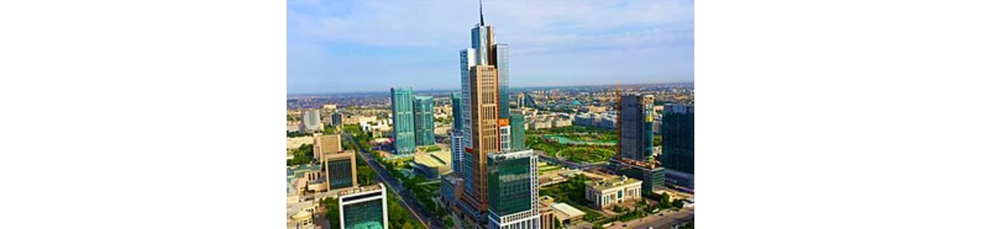 Aerial view of Tashkent skyline with modern skyscrapers and the prominent central tower under blue sky
