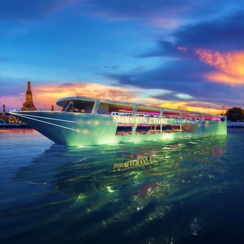 Illuminated Meridian Cruise boat on Dubai waters at sunset with Burj Khalifa in background
