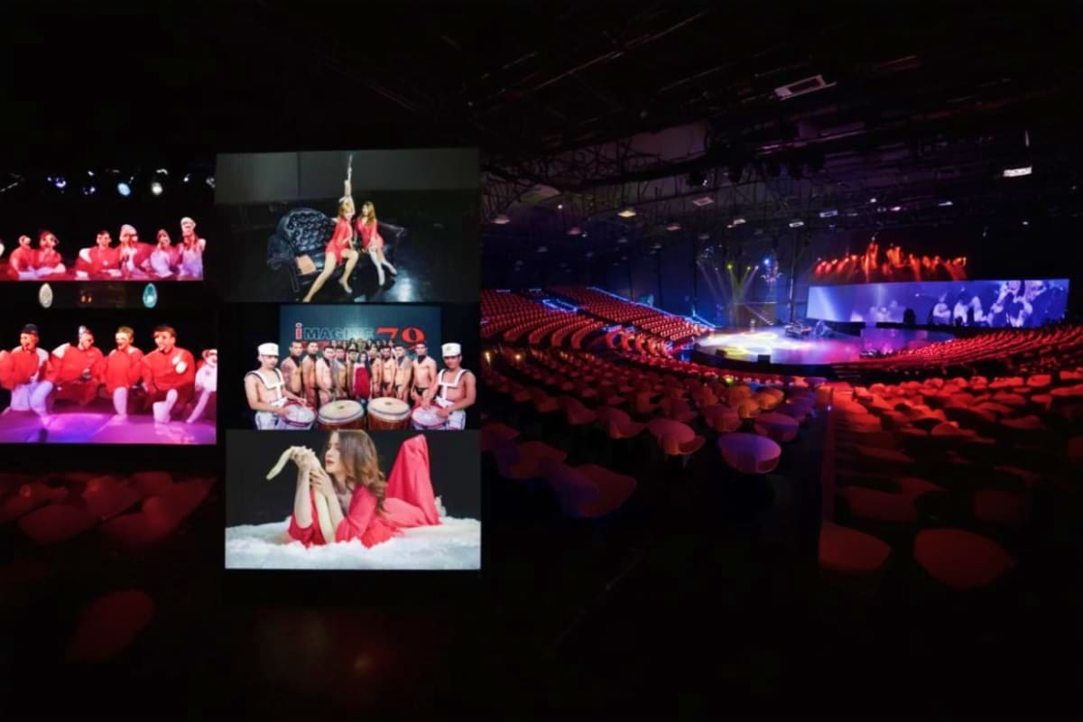 Russian Show Pattaya Large arena with red seats displaying multiple screens showing Russian performers in red costumes during a theatrical product