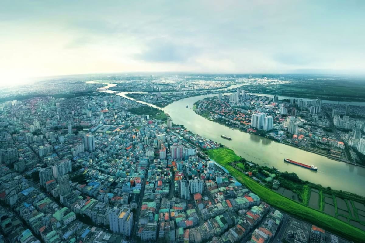 Landmark 81 Saigon Skyview Aerial view of Ho Chi Minh City with Saigon River winding through urban landscape and cargo ships below