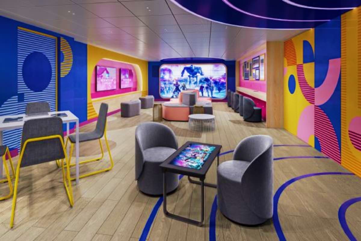 Norwegian Cruise Eastern Caribbean Cruise Modern cruise ship entertainment lounge with colorful blue, yellow, and pink geometric wall panels, gray seating, interactive