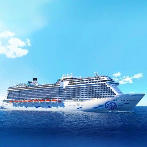 Large modern cruise ship sailing on blue ocean water under clear sky with white clouds