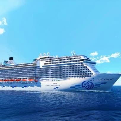 Large modern cruise ship with blue and white hull sailing on clear turquoise Mediterranean sea under blue sky