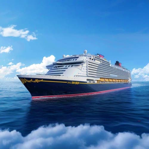 Large modern cruise ship sailing on calm blue ocean under clear sky with white clouds