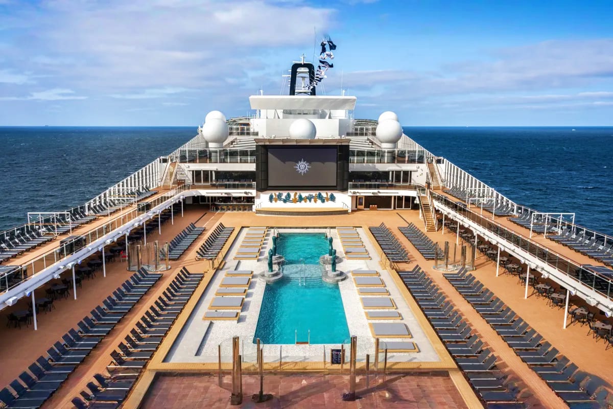Aerial view of MSC Euribia cruise ship deck with swimming pool, lounge chairs, and ocean horizon