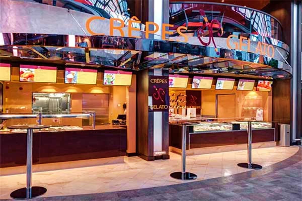 Crepes and gelato shop storefront with orange and brown interior, display cases, and menu boards in modern mall setting