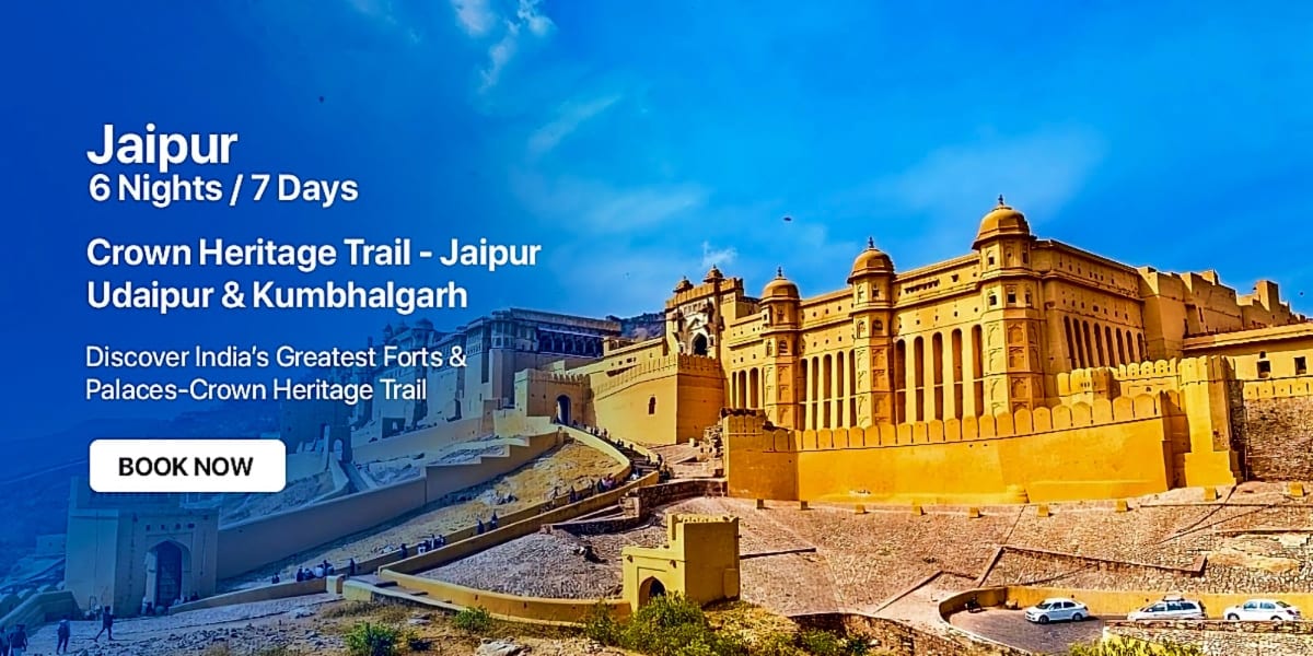 Amer Fort in Jaipur with golden-yellow sandstone walls, domes, and bastions against a blue sky