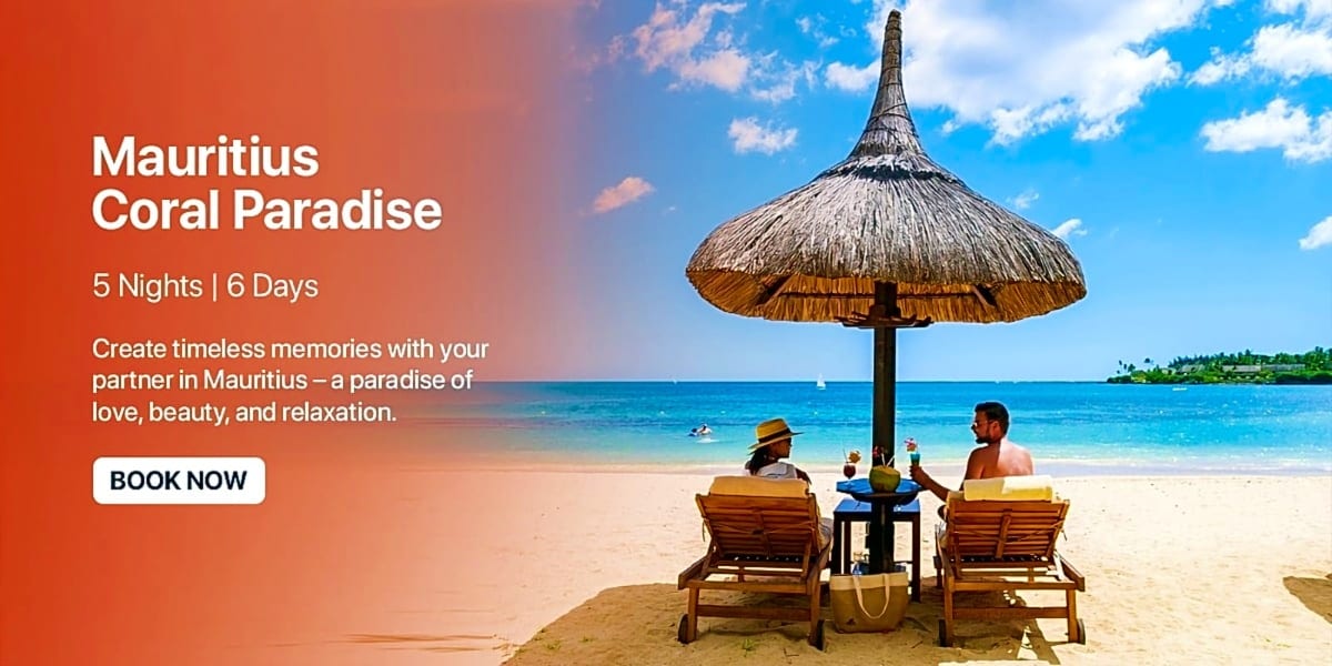 Couple relaxing under thatched umbrella on Mauritius beach with turquoise ocean and sailboat in background