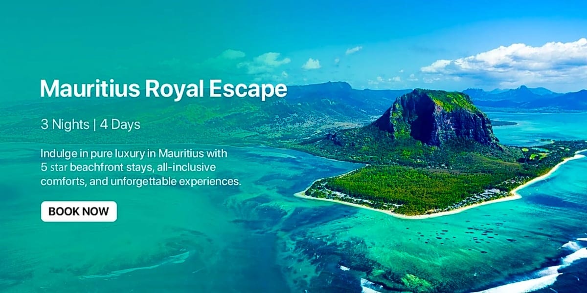 Aerial view of Mauritius island with turquoise ocean, white sandy beaches, lush green vegetation, and dramatic mountain peak