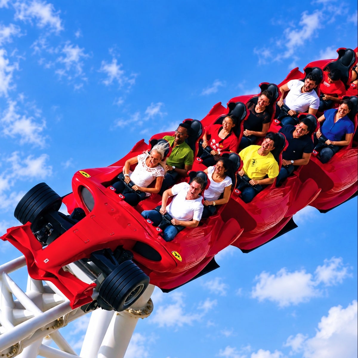 Excited passengers riding a red Ferrari-themed roller coaster against a bright blue sky at an Abu Dhabi theme park.